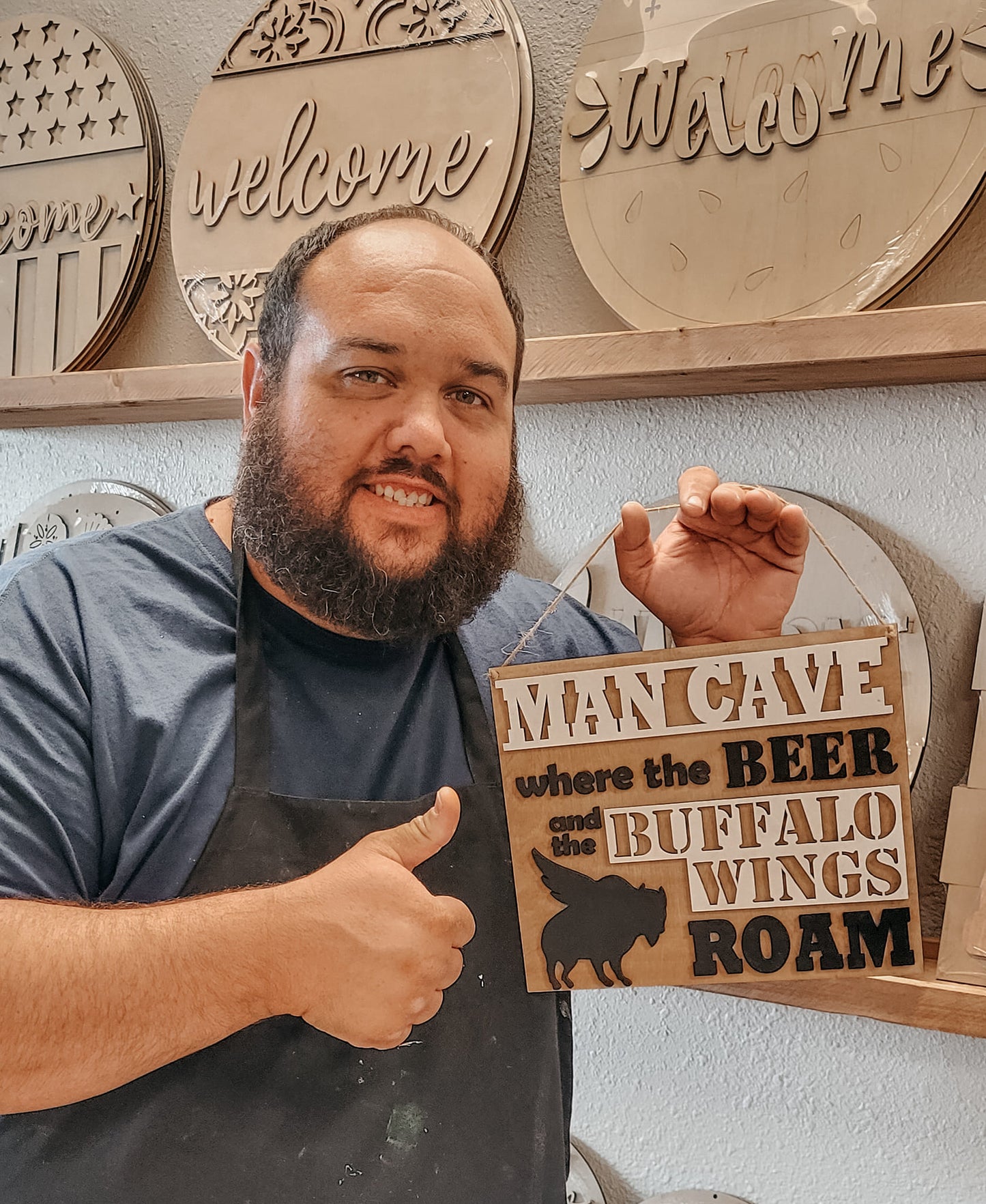 Finished man cave sign being held